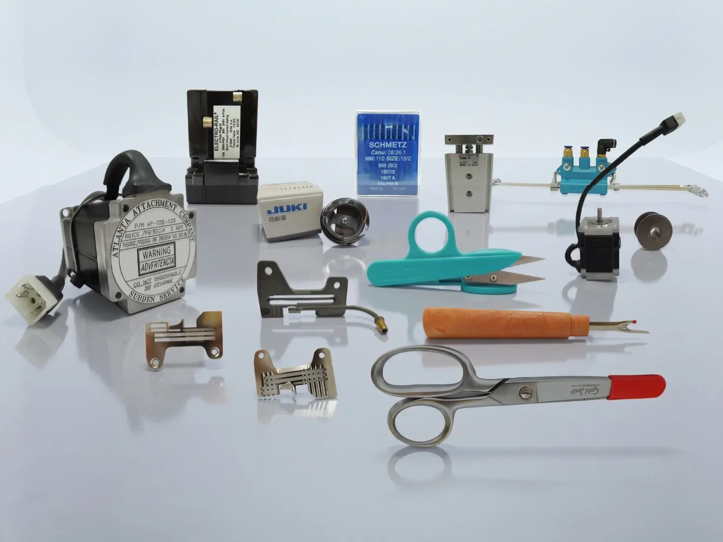 Genuine parts and accessories: an Atlanta Attachment motor, an Electro-Rail control box, Schmetz needles, a Juki bobbin case, folders and guides, pneumatic cylinders, a stepper motor, shears and a seam ripper